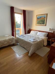 מיטה או מיטות בחדר ב-Hotel Fuori Città