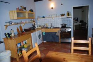 a kitchen with a table and a stove top oven at Chata pod klonami in Dziemiany