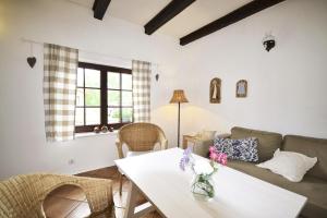 a living room with a table and a couch at Chata pod klonami in Dziemiany