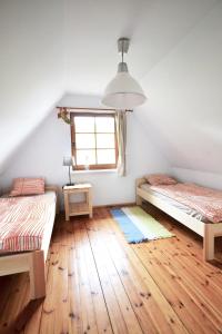 a room with two beds and a window at Chata pod klonami in Dziemiany