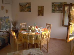 a dining room table with a yellow table cloth on it at B&B Fox's Hill in Urbania