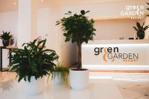 two potted plants sitting in front of a store at GREEN GARDEN Resort - Smart Hotel in Mestre