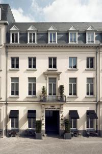 a large white building with a black door at The Dominican, Brussels, a Member of Design Hotels in Brussels