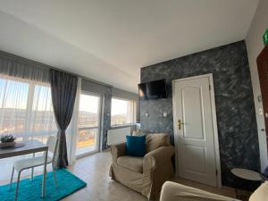 a living room with a couch and a table and window at TOP SKY VIEW - Studio Panorama in Veliko Tŭrnovo +16 photos