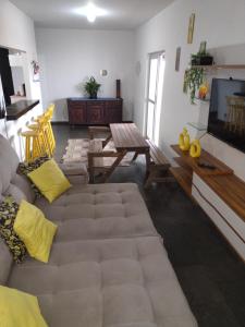 a living room with a couch and a flat screen tv at Apartamento Cobertura in São Pedro da Aldeia