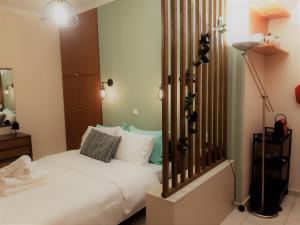 a bedroom with a white bed and a lamp at Παλατάκι in Patra
