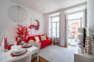 a living room with a red couch and a table at Akicity Campolide Apollo in Lisbon