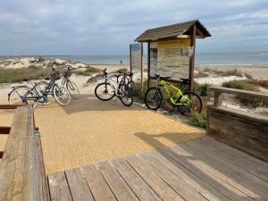 three bikes parked in front of a building at the beach at Palmeras Gold - Moderne villa (6p) met solarium/privézwembad in San Pedro del Pinatar