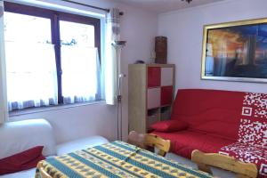sala de estar con sofá rojo y ventana en Family House With Balcony Garden Wi Fi, en Chamonix-Mont-Blanc