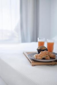 a plate of pastries and drinks on a table at Vista Infinita in Agios Ioannis Mykonos