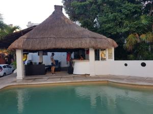 una cabaña con piscina al lado de una casa en tropical en Playa del Carmen