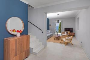 a living room with a mirror and a staircase at St Jakov Superior Beach Apartment with Free Parking in Dubrovnik