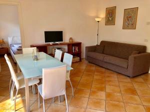 a living room with a table and a couch at Residenza Ai Ronchi 3 4 7 8 in Maccagno Superiore