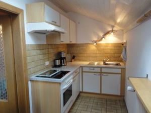 a small kitchen with a stove and a sink at Haus Fiedler in Piding