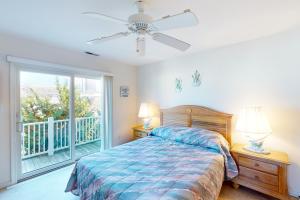 a bedroom with a bed and a balcony at Captain's Deck in Ocean City