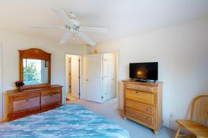 a bedroom with a bed and a flat screen tv at Captain's Deck in Ocean City