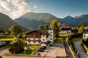 an aerial view of a village with mountains in the background at Dachsteinblick in Schladming