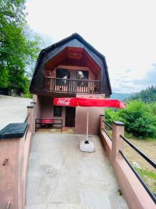 a building with a red umbrella in front of it at Likani house in Borjomi