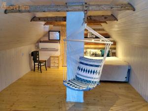 a room with a bed and a hammock in it at Self check-in Attic Suite next to Hiking Trails in Kärde