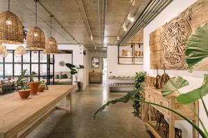 a room with tables and potted plants in it at Glory Wabi Sabi Hotel 清迈古城荣耀侘寂酒店 in Chiang Mai +49 photos