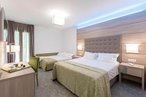 Postel nebo postele na pokoji v ubytování HOTEL TRILAGO