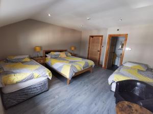 a bedroom with two beds in a room at The Swan Inn in Stranraer