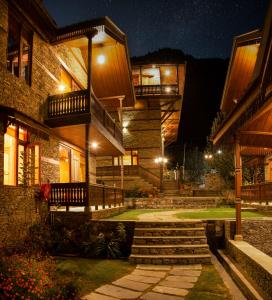 a house at night with stairs and lights at Shivadya - A Boutique Hotel in Manāli