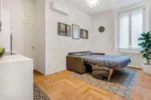 a living room with a couch and a table in it at New Milan Central Apartment in Milan