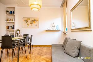 a living room with a table and a couch at Mecenate Apartment Fori Imperiali in Rome