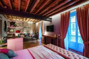 a bedroom with a bed and a living room at Vitrum - Como Luxury Suites in Como