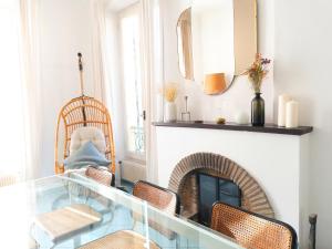 een woonkamer met een glazen tafel voor een open haard bij Maison Trenca in Menton