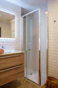 a glass shower in a bathroom with a tub at Girasol Altea Playa in Altea