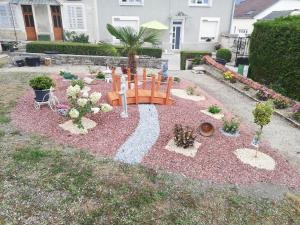 a garden with a playground in the middle of a yard at Gîte du capitaine 4 étoiles in Maranville