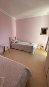 a bedroom with two beds and two tables at Casa em bairro nobre, bem localizada, com suite. in Bento Gonçalves