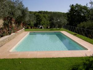 a large swimming pool in a yard with grass at Baccio di Magio in Arezzo
