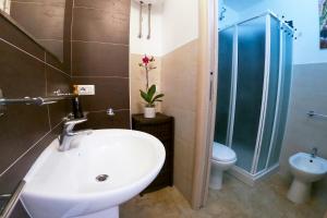 a bathroom with a sink and a shower and a toilet at West Sardinia Apartments in Càbras +39 photos