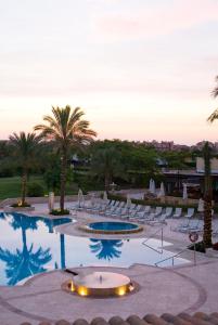 
a beach scene with a large swimming pool at Caleia Mar Menor Golf & Spa Resort in Torre-Pacheco
