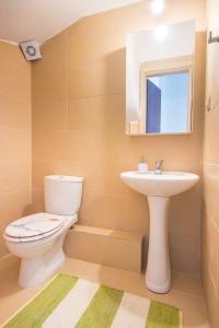a bathroom with a toilet and a sink at Ekavi Villa in Skala Potamias +28 photos