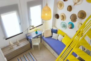 a room with a blue couch and a table at Ekavi Villa in Skala Potamias