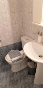 a bathroom with a toilet and a sink at Παλατάκι in Patra +25 photos