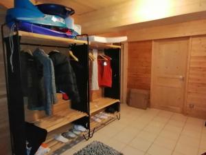 a walk in closet with wooden walls and wooden shelves at Chalet Les Pins Blancs in Allos