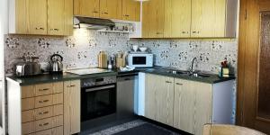 a kitchen with a sink and a stove top oven at Ferienwohnung Walter Gluche in Pittenhart