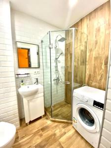a bathroom with a washing machine and a washer at Snow Forest Bakuriani Apartment 10 in Bakuriani +5 photos