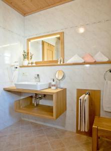 a bathroom with a sink and a mirror at Haus Wiesengrund in Frauenau +38 photos