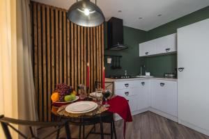 a kitchen with a table with a bowl of fruit on it at WOODkz in Oral