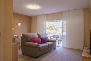 a living room with a couch and a balcony at Club Náutico Altea Playa in Altea