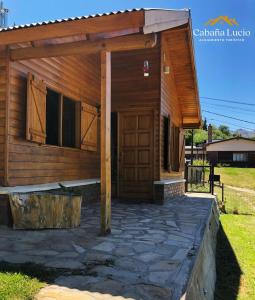 a small wooden cabin with a large door on it at Cabaña Lucio in Esquel