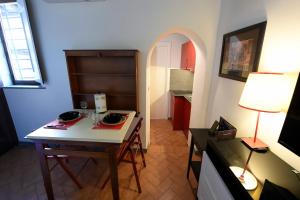 a living room with a table and a dining room at Grottino - Campo de' Fiori in Rome +17 photos