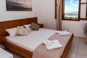 a bedroom with a bed with two towels on it at Galini in Agia Irini Milos