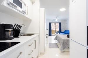 a white kitchen with a sink and a microwave at Listen THE STARS 505 - Los cristianos in Los Cristianos